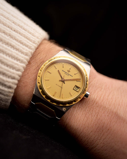 Vacheron Constantin 222 Ref 46003 Vintage watch from the 1980s, two-tone steel and 18k gold, golden Sigma dial, automatic movement on a wrist on black background